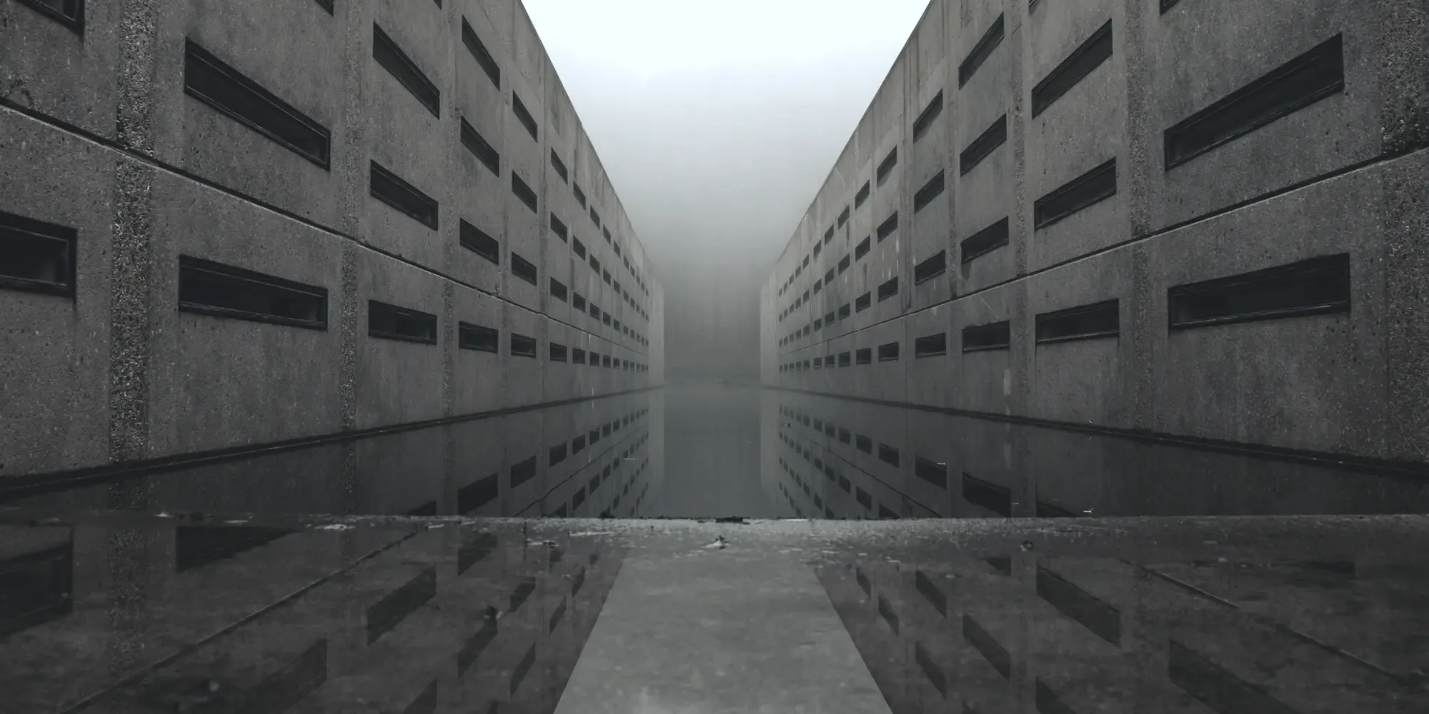 Fog and reflections between two rows of concrete buildings